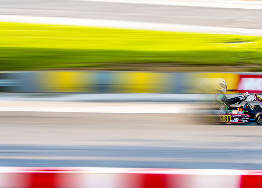 Photo of child blurred on gokart track.