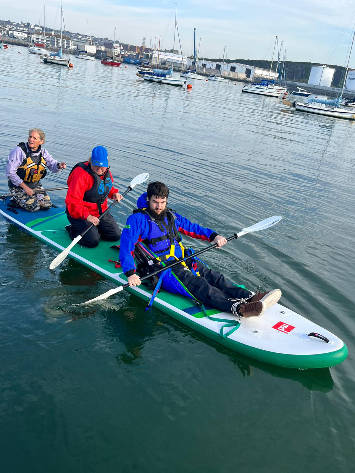 A man is being taught how to kayak on Plymouth Sound.